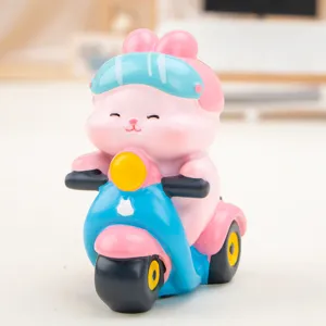 Detailed close-up of a cute pink rabbit resin ornament riding a blue scooter toy