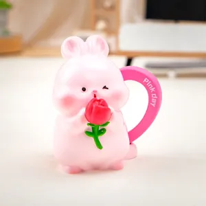 Detailed view of a cute pink Nini rabbit resin figurine holding a small red rose flower