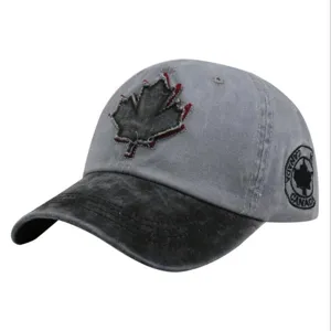 Macro view of the washed distressed baseball cap featuring a vintage maple leaf applique