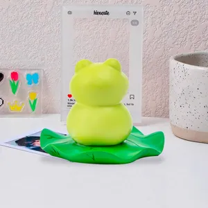 Back view showing the rounded texture of the green frog figurine on lotus leaf base.
