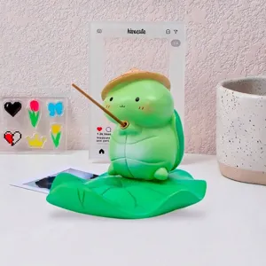 Cute creative green frog turtle phone stand on a lotus leaf base for desktop decor