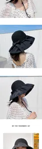 Stylish black sun hat with large brim and bow detail for summer UV protection