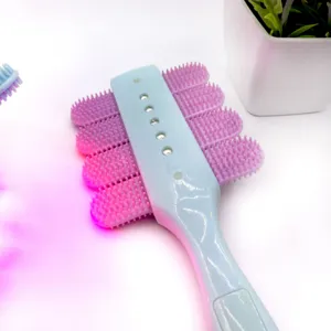 Pet massage brush with soft silicone bristles and blue handle for grooming cats and dogs.