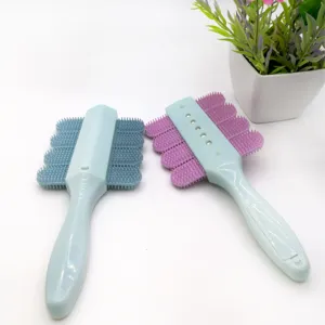 Detailed view of pet grooming brush featuring soft silicone bristles for daily massage.