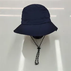 Macro detail view of navy blue waterproof quick-dry bucket hat with adjustable strap
