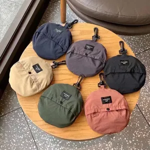 Packable quick-dry waterproof bucket hats in six colors displayed on a wood table