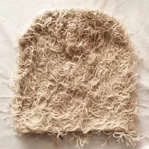 Detailed close-up view showing the shaggy and textured fabric of the fuzzy knit beanie