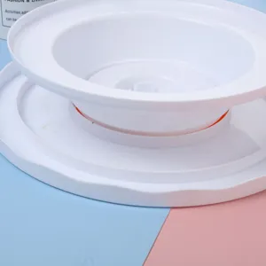 Close-up detail of white plastic cake turntable, manual rotating design for easy baking crafts.