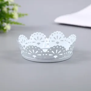 White iron lace tray detail showing exquisite hollow carved edges and smooth round base surface.