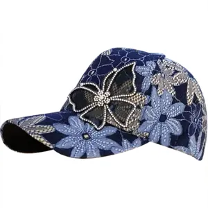 Detailed side view of blue lace mesh baseball cap featuring a rhinestone butterfly.