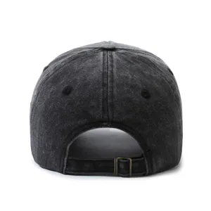 Detail view of the adjustable metal buckle on a distressed black cotton baseball cap.