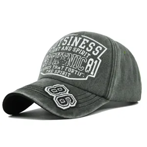 Detailed view of distressed gray baseball cap featuring bold white 86 embroidery and text