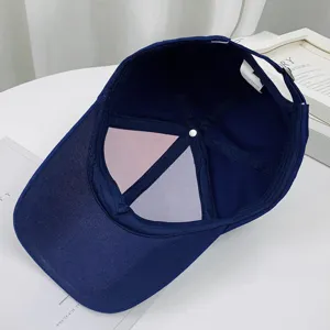 Detail view of the interior lining and 100% cotton label of a navy baseball cap