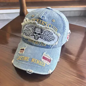 Nahaufnahme einer Used-Denim-Baseballkappe mit Totenkopf-Stickerei.