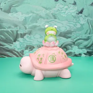 Detailed macro shot of the pink turtle figurine with a cute green frog sitting on top
