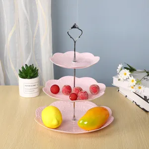 Detailed view of the pink 3-tier dessert tray showing the embossed floral pattern and stand.