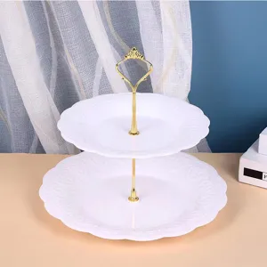 Close-up detail view of the white plastic two-tier dessert tray with golden metal handle.