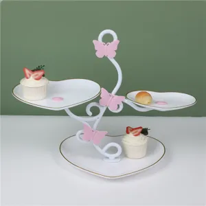 Detailed view of 3-tier heart shaped dessert display stand for afternoon tea scene.