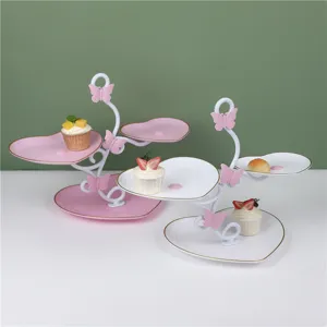 Details of the multi-tier heart shaped dessert display stand with cute butterfly accents.