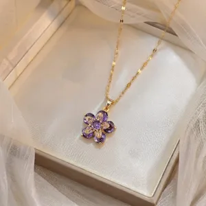 Close-up of an elegant purple zircon flower pendant necklace presented in a gift box