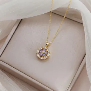 Detailed view of elegant gold-tone necklace featuring purple floral zirconia pendant