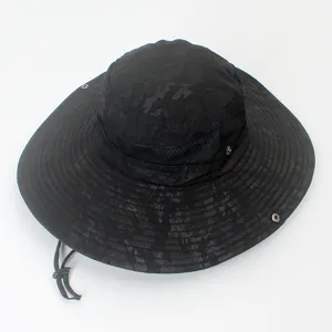 Top view detail of wide-brim black camouflage boonie hat with adjustable chin strap