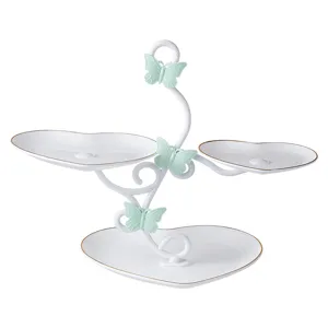 Detail view of the 3-tier ceramic heart dessert stand with cute mint green butterflies.