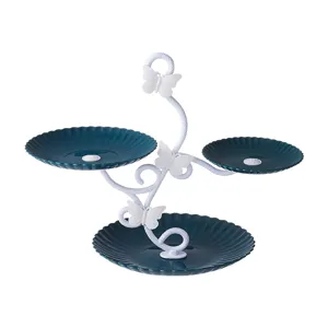 3-tier dessert stand detail showing dark green scalloped plates and elegant white butterfly bracket.