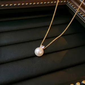 Minimalist gold titanium steel necklace with a single elegant white pearl pendant