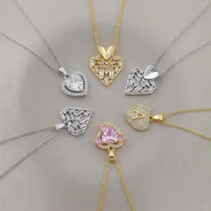 Detail view of various heart-shaped zircon pendants with silver and gold chains