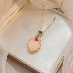 Close-up detail of an elegant heart-shaped zircon pendant with colorful gemstone accents.