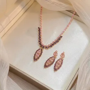 Close-up detail of elegant pink and purple marquise zircon necklace and earrings set