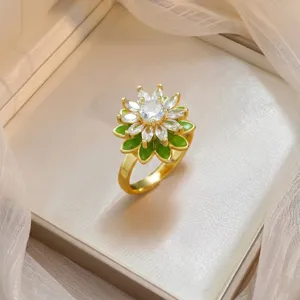 Elegant gold-plated flower ring with marquise-cut cubic zirconia and green enamel detail