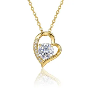 Detailed close-up of a gold heart pendant necklace featuring a sparkling round stone.