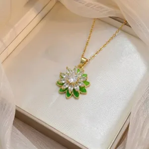 Detailed view of a gold-plated flower pendant necklace with green petals and zircons