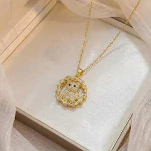 Detail view of gold plated necklace featuring a sparkling zircon encrusted bear pendant