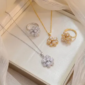 Close-up of rotating zircon flower necklaces and rings in gold and silver finish