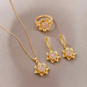 Close-up of golden sunflower jewelry set with pink zircon and sparkling stones