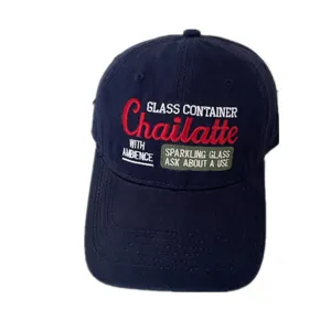 Macro view of high-quality embroidery detail on a classic navy blue baseball cap.