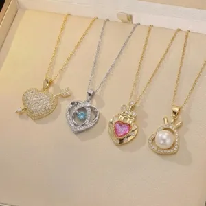 Close-up of four assorted heart necklaces in gold and silver, featuring pearls and gems