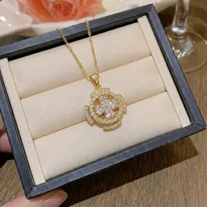 Detailed view of gold necklace with marquise zircon flower pendant in gift box