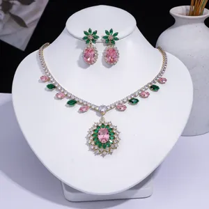 Parure de bijoux de mode élégante avec zircons roses et verts sur support blanc