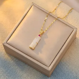 Close-up view of elegant bamboo joint white chalcedony pendant with a gold-tone chain