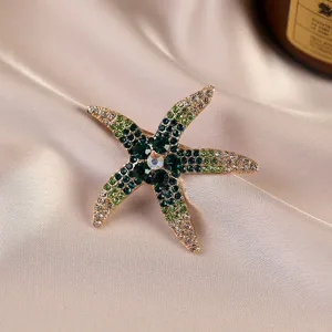 Detailed close-up shot of exquisite rhinestone starfish brooch with sparkling gems.