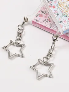 Clear PVC storage pouch with star keychains and floral notebook insert detail shot.