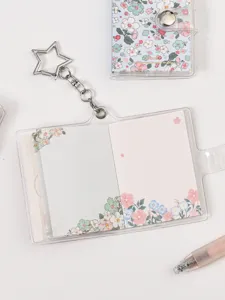 Transparent mini binder notebook with floral inner pages and star keychain for daily journaling.