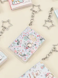 Mini transparent notebook with cute floral cat covers and star keychain pendant for daily journaling.