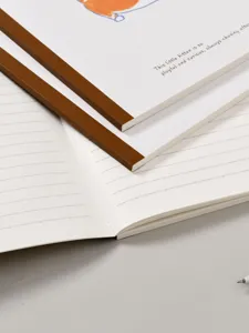 Cahier ligné minimaliste avec dos marron et illustration de chaton pour étudiants.