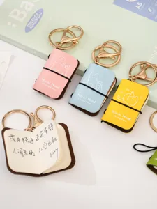 Mini cute notebook keychain set with PU leather cover and cat illustrations. Multi-color.