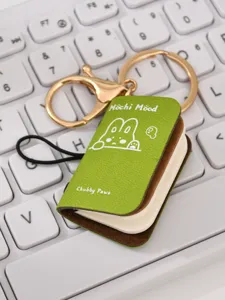 Mini book keychain with cute bunny design, PU leather notebook pendant for keys and bags.